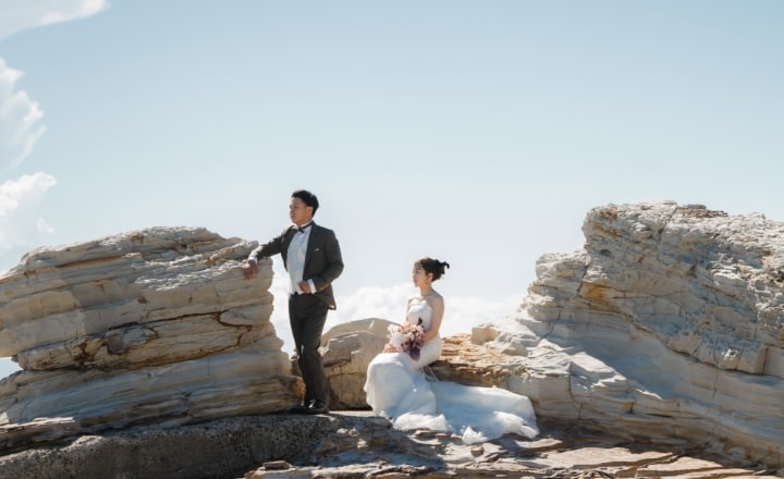 Noma Lighthouse｜洋装姿のカップルが岩礁を背景に撮影をしているイメージ