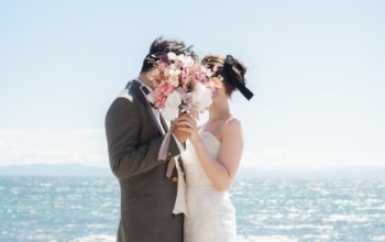 Noma Lighthouse｜洋装姿のカップルが海を背景に撮影をしているイメージ